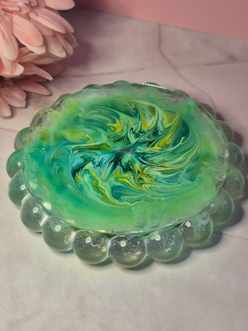 Back of green resin trinket tray with flowing ink patterns throughout