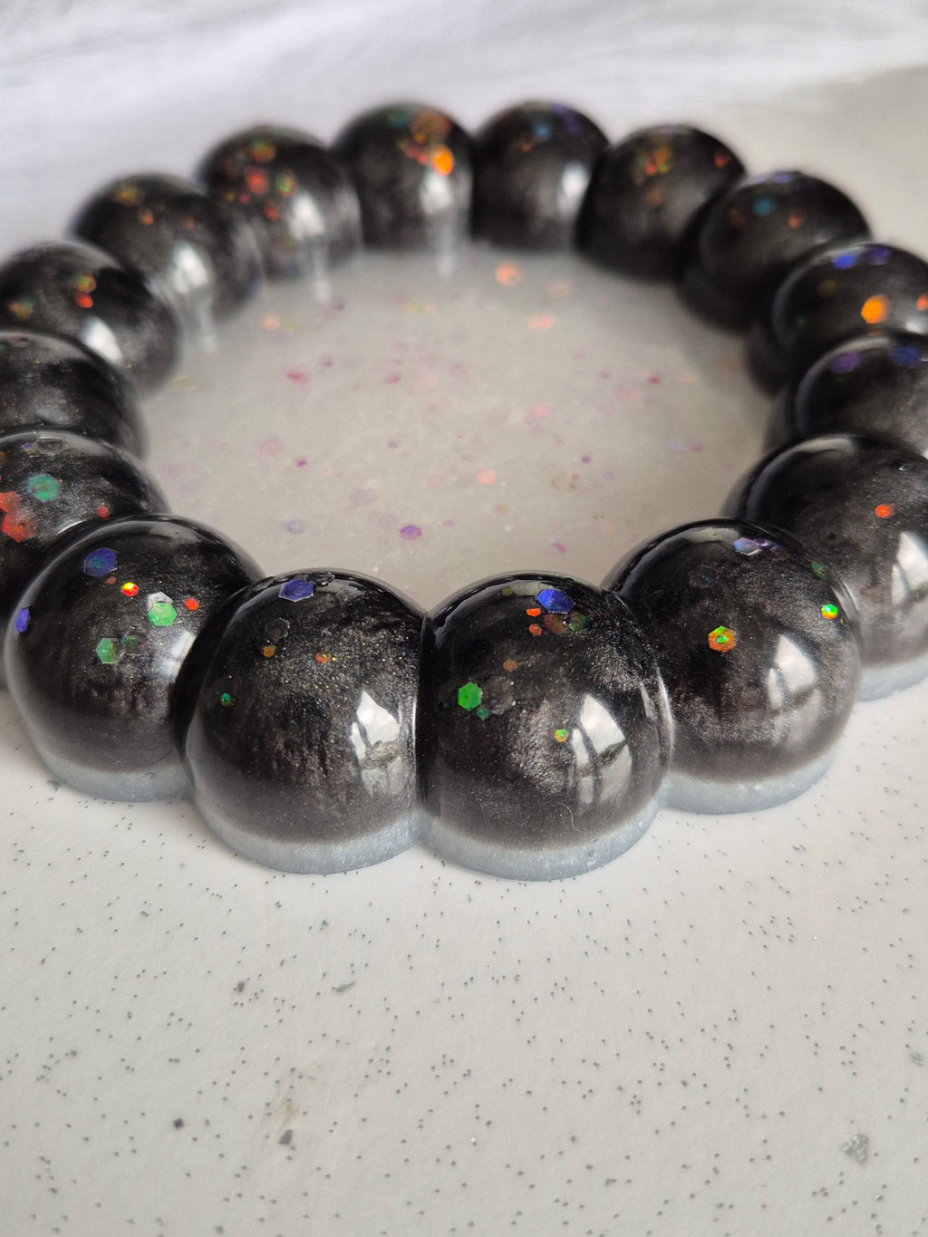 Black and white bubble trinket tray on a white marble worktop 