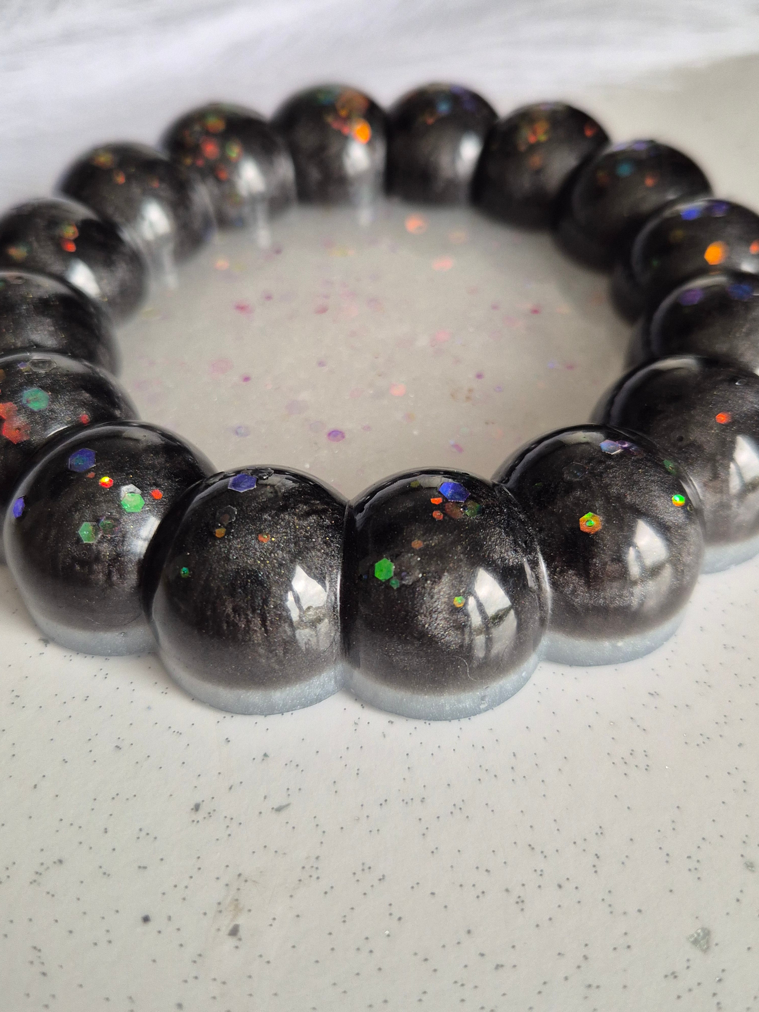 Black and white bubble trinket tray on a white marble worktop 