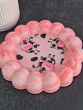 Handmade pink and white marbled bubble-edge trinket dish with playful cow-print fabric decoupage in the centre.