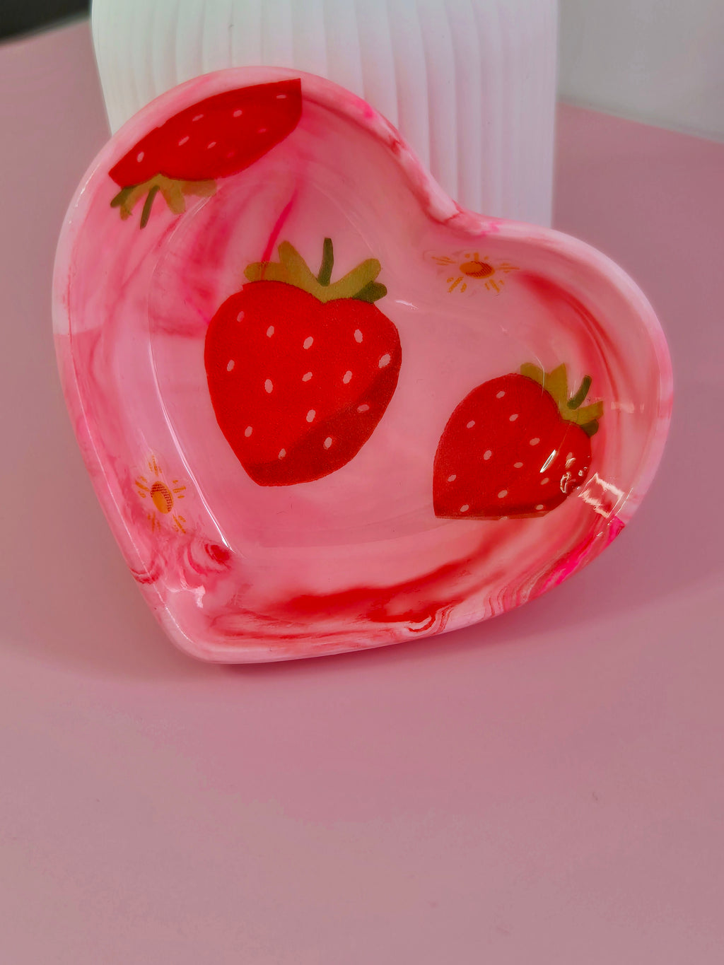 Pink strawberry heart trinket dish displayed upright with red decoupage strawberries inside the dish.
