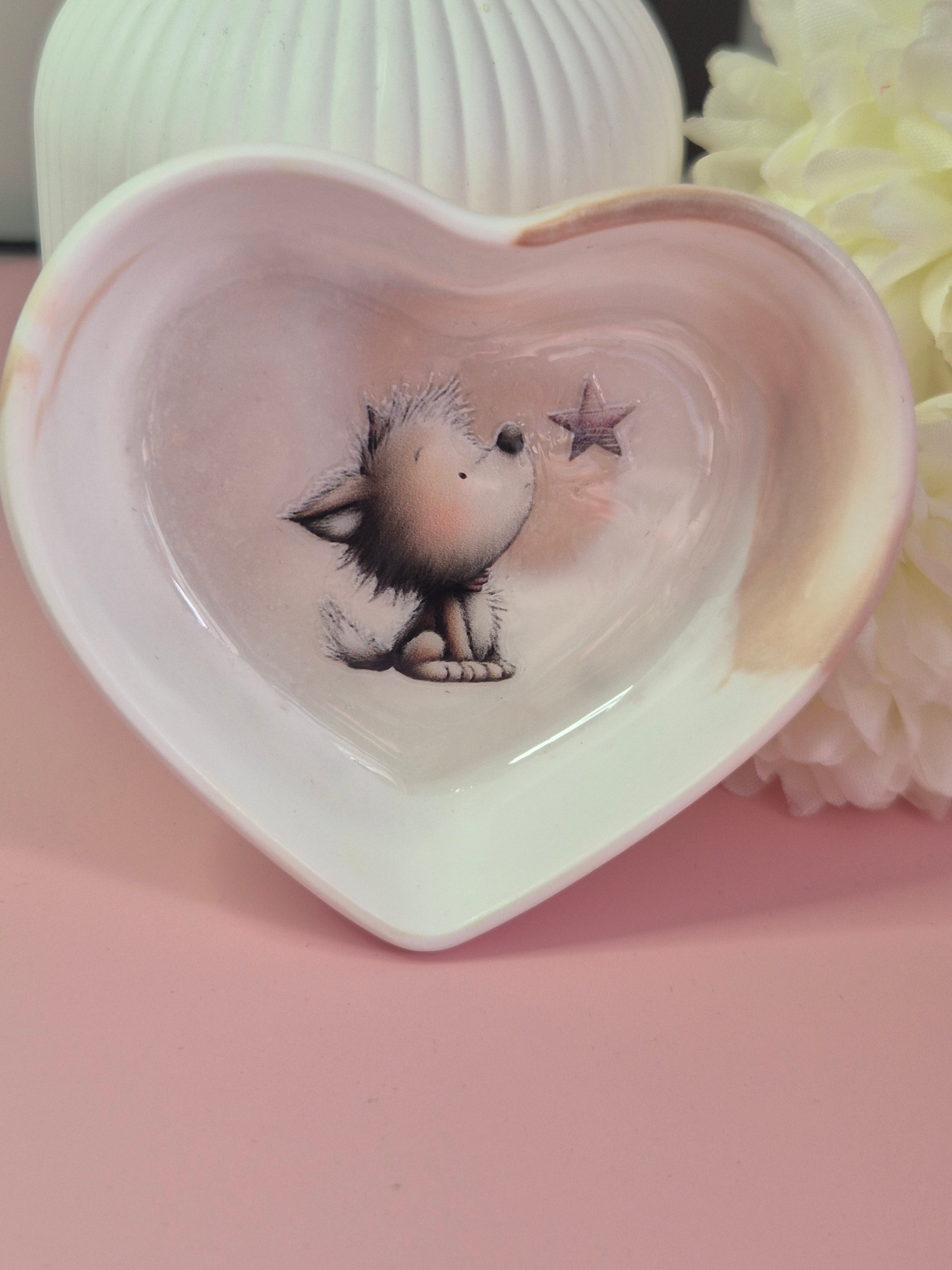 Close-up of the Puppy Wishes Heart Trinket Dish showing the smooth cream swirl finish and puppy illustration inside.