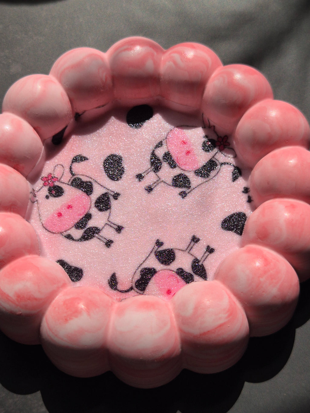 Pink marbled bubble-edge jewellery dish with black, white and pink cow-print fabric applied to the inner tray.