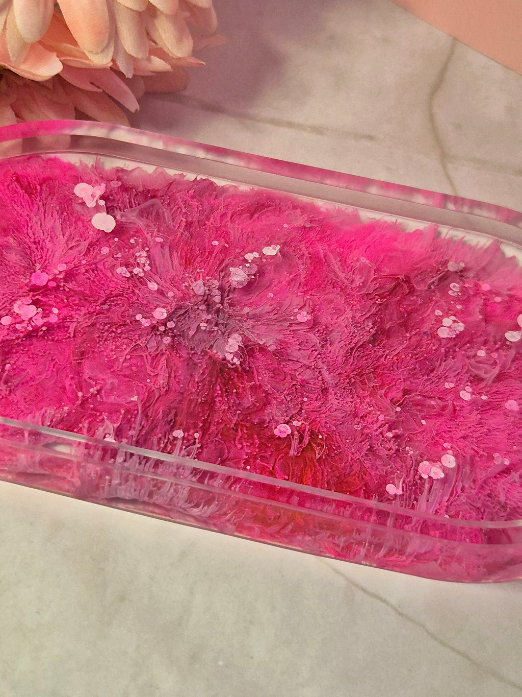 close up petri dish effect trinket tray with coral like ink patterns styed with a soft pink flowers