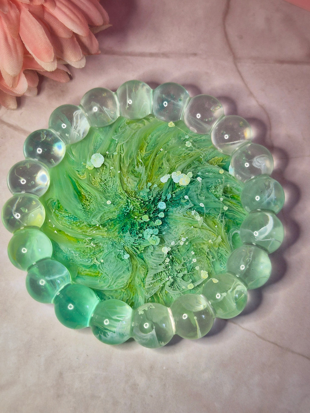 Green resin trinket tray with flowing ink patterns throughout