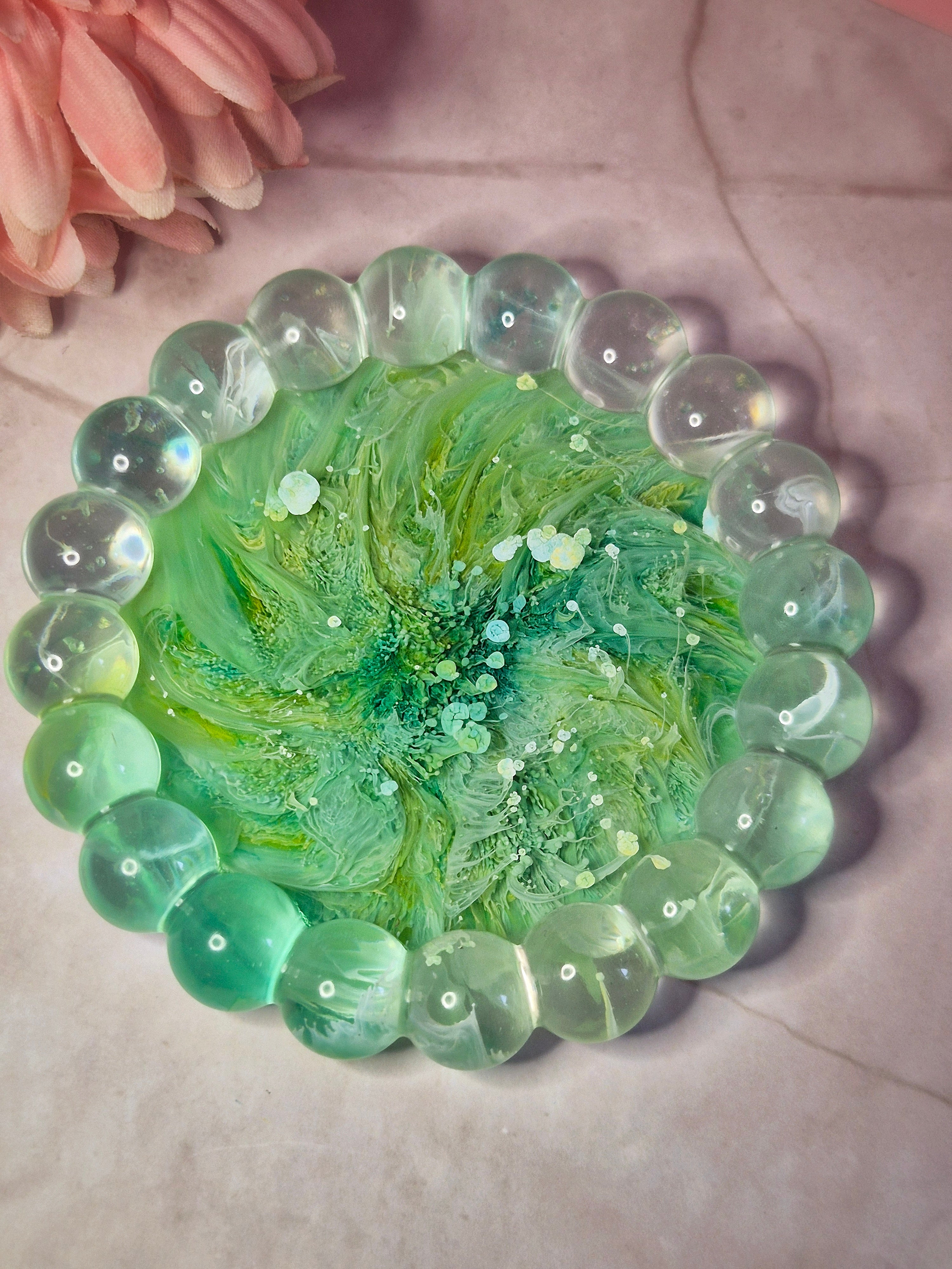 Green resin trinket tray with flowing ink patterns throughout
