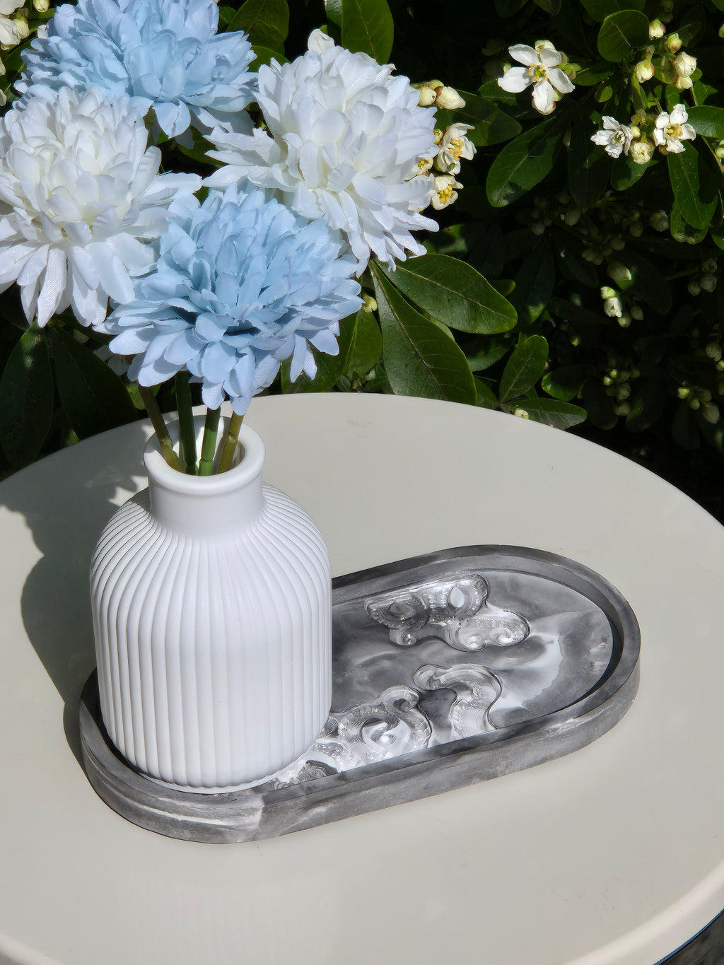 octopus resincrete trinket tray on a table with vase and flowers
