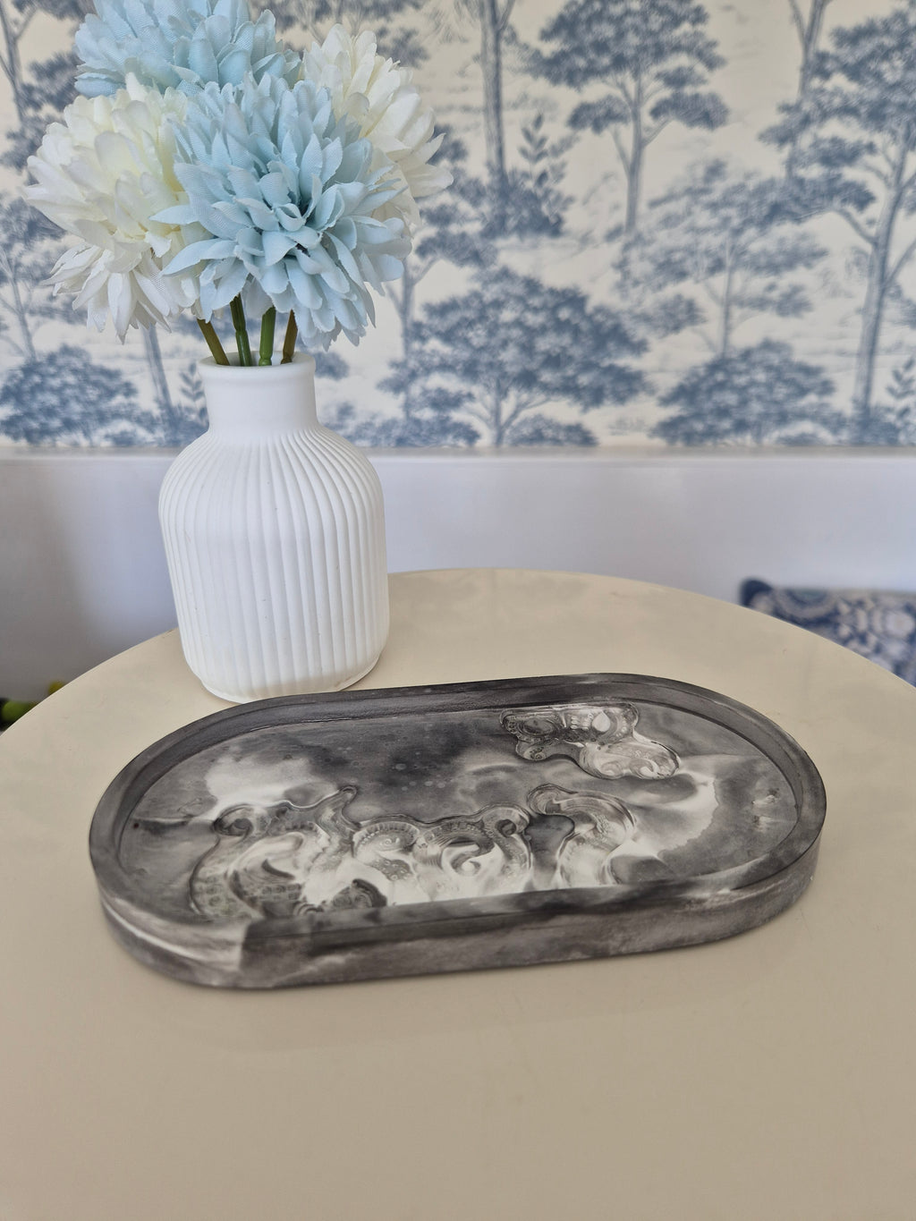 resincrete black & white trinket tray on a table with vase and flowers